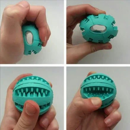 Hand squeezing a teal rubber dog chew ball with teeth-cleaning grooves