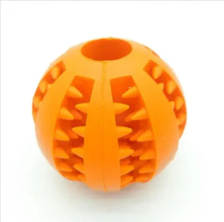 Orange rubber pet chew ball with textured grooves and spikes on white background