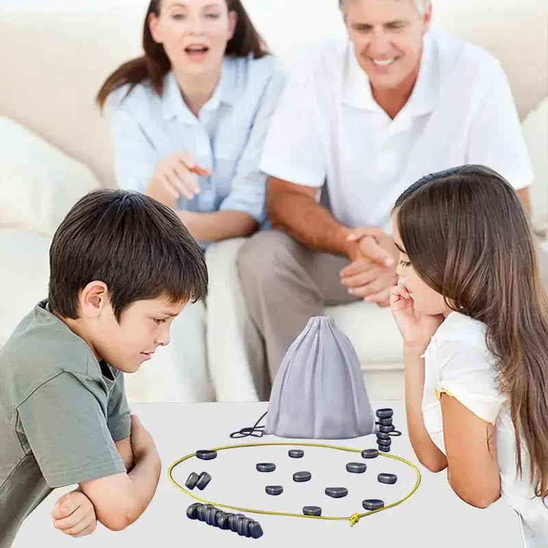 Children playing tabletop ring toss game with family watching in a living room setting