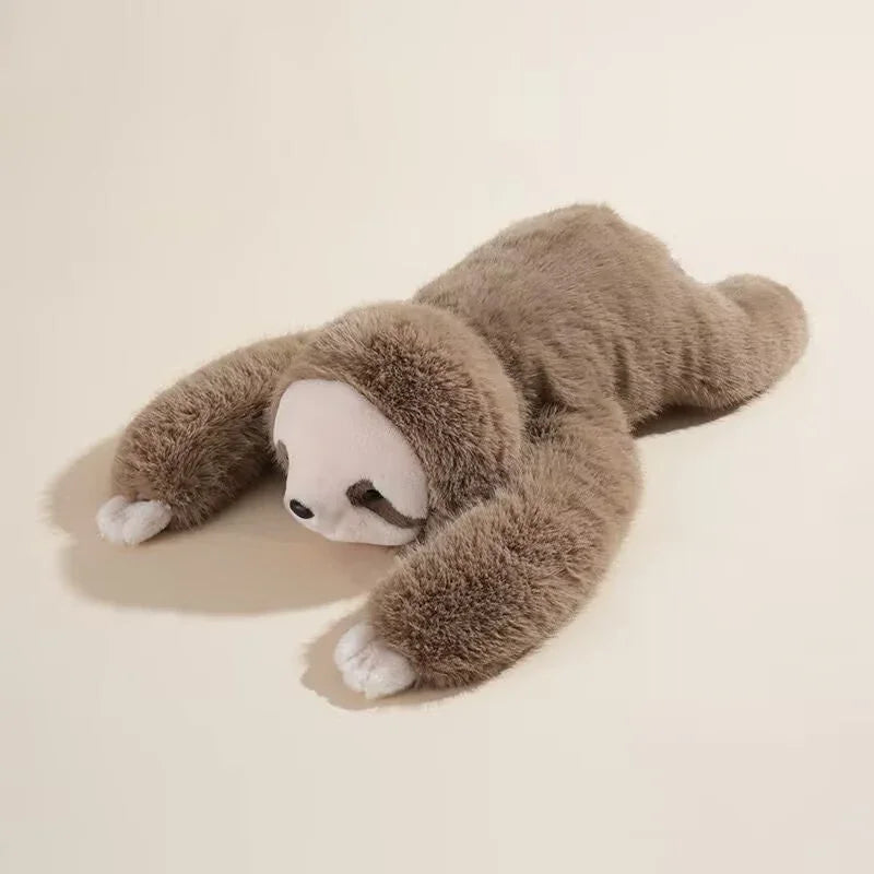 Cute brown sloth plush toy lying flat on a cream background