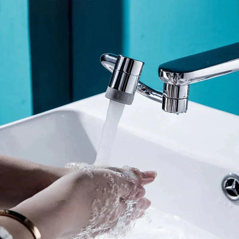 Hand washing under modern chrome bathroom faucet with blue wall background