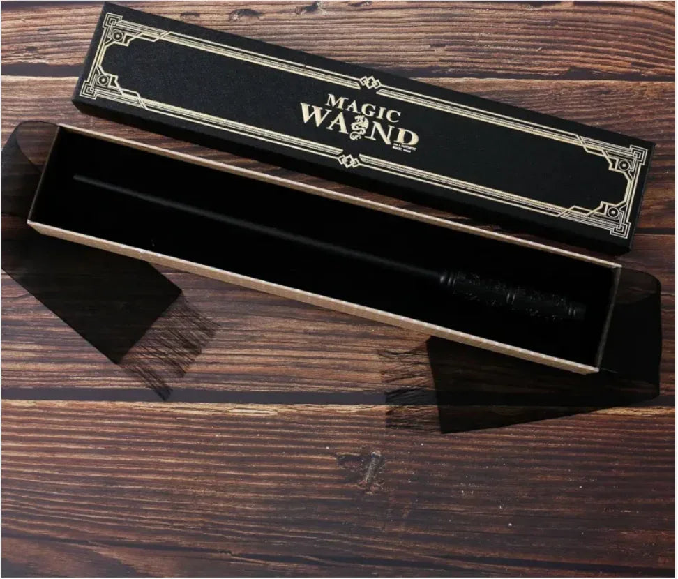 Black magic wand in decorative gift box on wooden table