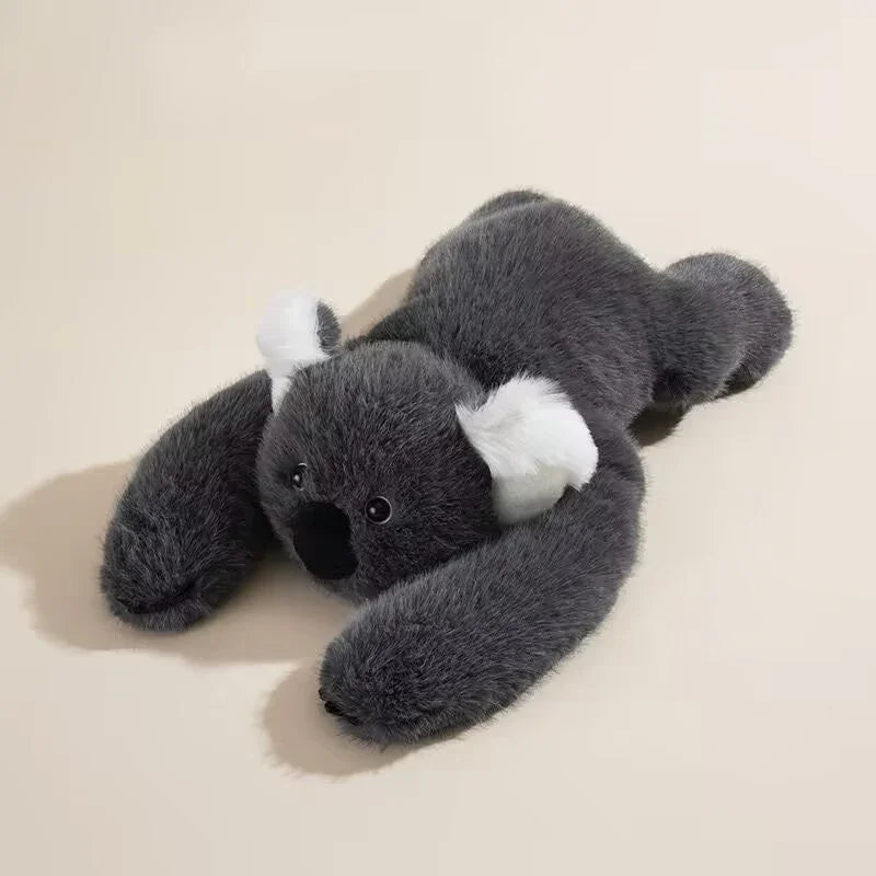 Gray plush koala toy with white ears on a light background